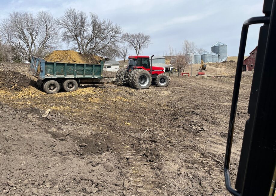 tracktor pulling dirt in mud field